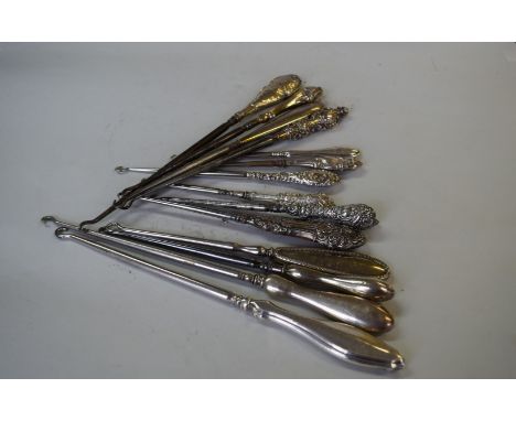 Fifteen various silver handled button hooks.