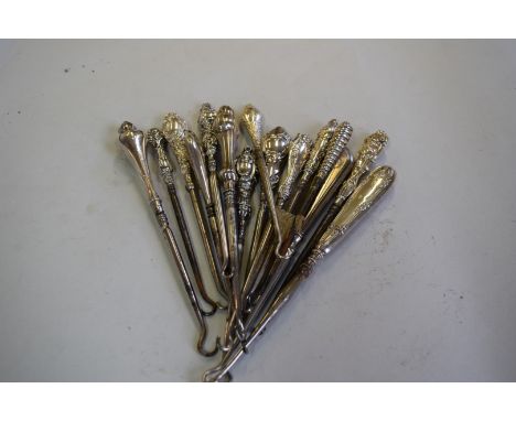 Fifteen various silver handled button hooks.