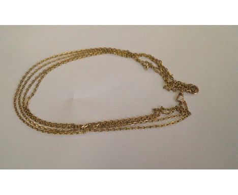 An unmarked yellow metal muff chain, 158cm.