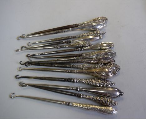 Fifteen various silver handled button hooks.