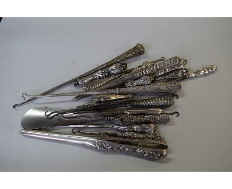 Two silver glove stretchers, one by W Comyns; together with eight various silver handled button hooks; two white metal handle