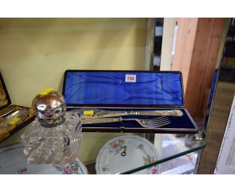 A large square glass and electroplate mounted inkwell; together with a cased pair of electroplated fish servers.