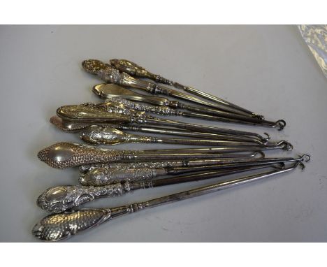 Fifteen various silver handled button hooks.