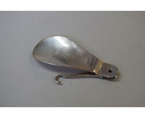 A Victorian silver folding shoe horn and button hook, by James Deakin & Sons, Chester 1900, 15.5cm extended, 54g.