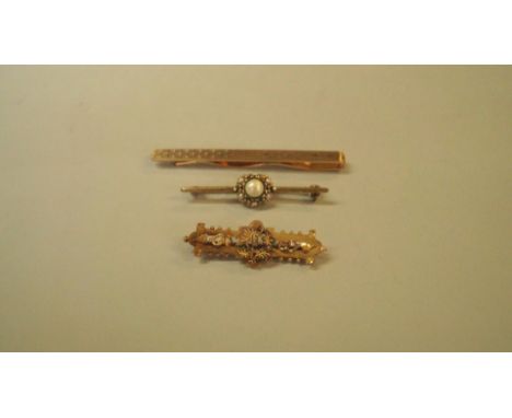 A 9ct bar brooch; together with a tie clip; and another bar brooch. [3]