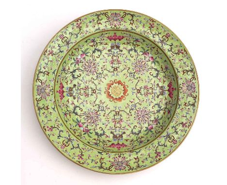 Light green ground with Famille Rose enamels depicting florals and bats with gilt accents, Jiaqing mark, 38 cm. in diameter. 