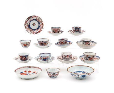 11 cups and 12 saucers in Imari decors, largest saucer is 13 cm., in diverse conditions.