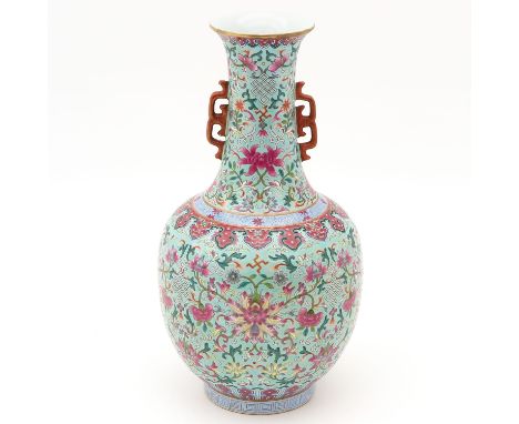Light green ground with Famille Rose florals, Qianlong mark, 34 cm. tall. 