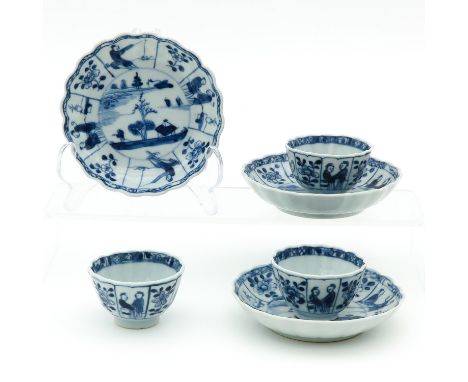 Blue and white decor depicting garden scene, border with flowers and Chinese figures, saucers are 11 cm. in diameter.