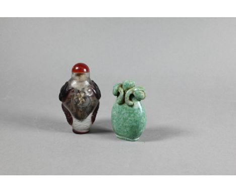 A Chinese Peking cameo glass ovoid snuff bottle with red stopper, the clear glass bottle inside painted with figures and over