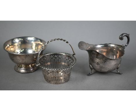 Late Victorian pierced silver bonbon basket, Birmingham 1900, to/w a sugar basin on raised foot-rim, Birmingham 1921 and a si