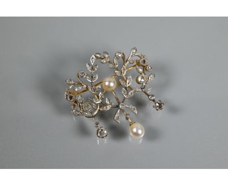 An Edwardian diamond and pearl brooch, the open design formed of leaf tendrils set with mixed cut diamonds, with central pear
