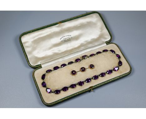 A Victorian rivière necklace, formed of twenty four foil-backed oval faceted purple pastes in gilt metal setting, 40 cm long,