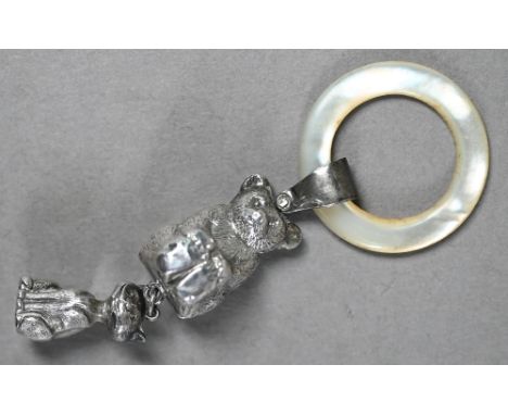 An Edwardian silver baby's rattle with mother of pearl teething ring, hung with teddy bear and grinning cat, William Vale &am