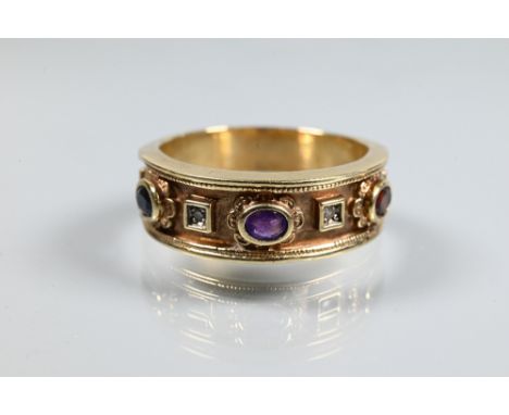 A 9ct yellow gold gentleman's ring in the Victorian Gothic revival style set with oval garnet, sapphire and amethyst, with tw