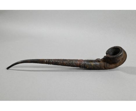 An antique Tibetan Buddhist ritual pipe with moulded clay bowl inserted into the long embossed copper handle, 24.5 cm o/a&nbs