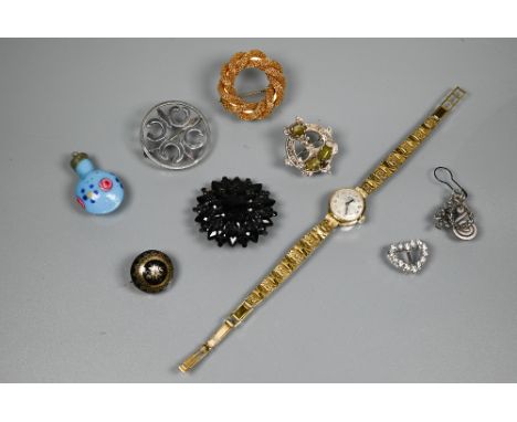 A small collection of jewellery items including a jet mourning brooch stamped Acker, a Victorian piqué work mourning brooch, 