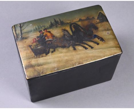 A 19th century Russian lacquered papier maché tea caddy, the cover painted with a family in horse-drawn troika in the snow, 1
