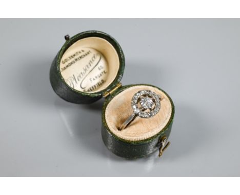 An antique diamond floating halo cluster ring formed of a central old cut diamond with diamond surround, white metal set stam