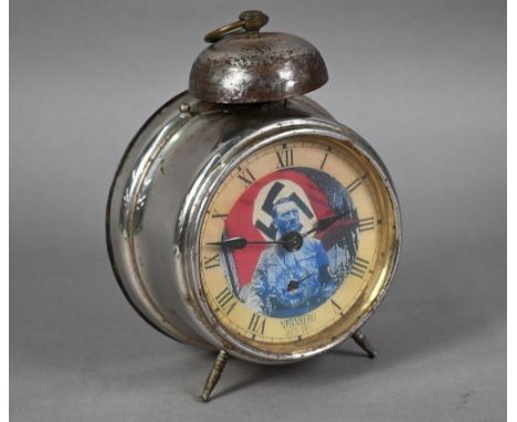 A WWII period Nuremburg rally clockwork alarm clock, the dial with portrait of Adolf Hitler before a swastika flag and titled