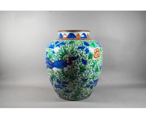 A large Chinese wucai vase, late Qing, painted in underglaze blue, copper red and polychrome enamels with two large phoenix, 