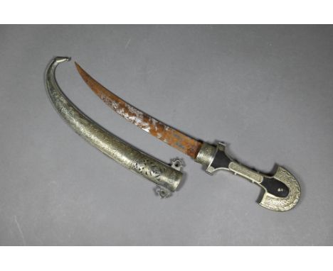 An Arab dagger Jimbaya with 23 cm curved blade on wooden hilt with engraved low-grade white metal mounts and engraved scabbar