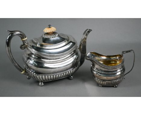 Regency silver teapot of oblong form with half-reeding and guilloche band, ivory finial and insulators, on ball feet, to/w th