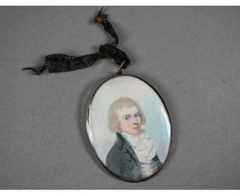 A Georgian oval portrait miniature on ivory of a young gentleman, circa 1790, with extravagant neck-cloth and grey coat, in g