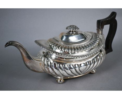 George silver teapot in the Regency style, of half-reeded oblong form with foliate finial, gadrooned rims and bun feet, with 