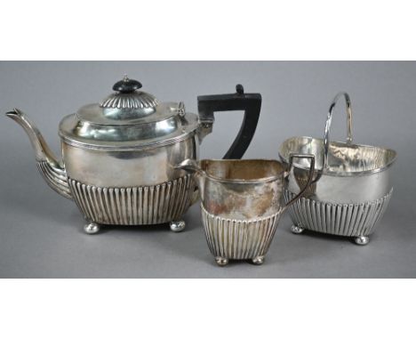 Victorian silver three-piece bachelor tea service of half-fluted oblong form, on bun feet, Martin, Hall &amp; Co, Sheffield 1