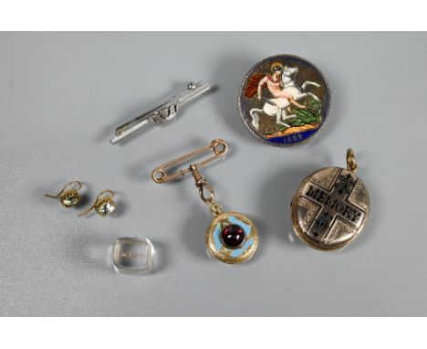 A Victorian oval Memento Mori locket, the back with overall chased decoration, the front bearing a cross with black enamel 'M