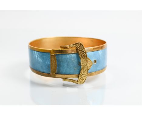 A gilt metal and turquoise enamel bangle in the form of a buckle with stylised 'spider web' enamel decoration, in as found co