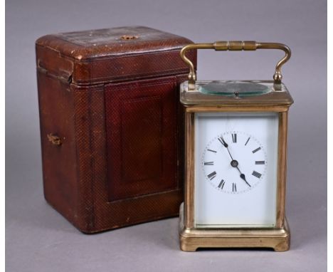A traditional brass 8-day carriage clock, the twin drum hour repeat movement white enamelled with roman numeral, striking the