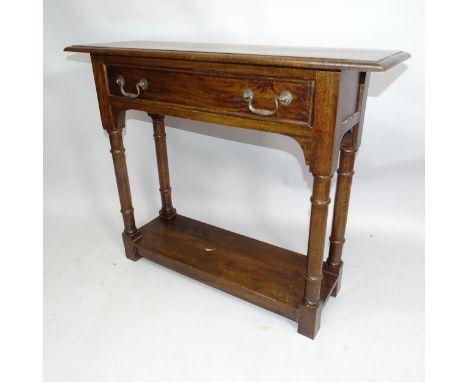 A arts and crafts style oak console table with single fitted drawer. 93cm x 76cm x 32cm 