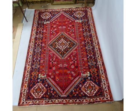 A red-ground Hamadan carpet. 275cm x 180cmIn overall good used condition. There is a patch repair (photographed). Some areas 