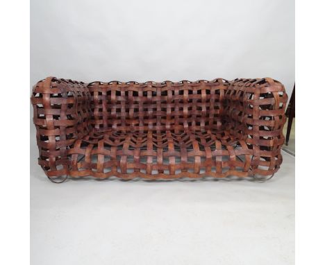 A mid-century sculptural woven leather strap sofa, the leather straps supported on welded steel frame. 175cm x 75cm x 92cm 