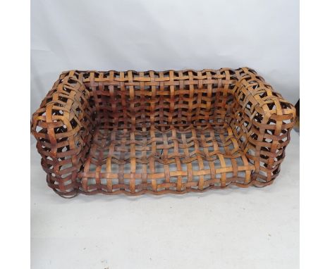A mid-century sculptural woven leather strap sofa, the leather straps supported on welded steel frame. 170cm x 75cm x 90cm 