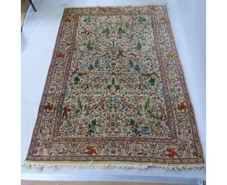 An Iranian cream-ground rug, the central lozenge and borders decorated with hunting scenes. 215cm x 154cmCarpet in fair overa