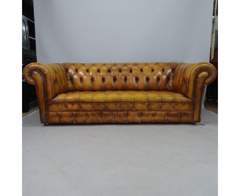 A buttoned brown leather-upholstered Chesterfield sofa, 200 x 80 x 85cm 
