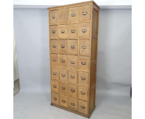 A Vintage oak bank of 28 drawers, 78cm x 179cm x 35cm 