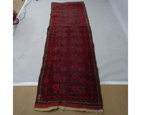 A red ground Turkish runner, 285 x 90cmThere is an oval 20cm visible patch repair, other smaller areas of repair, visible par