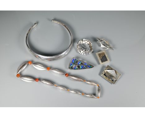A silver necklace formed of elliptical pods with graduated cornelian beads between, London 1970, maker TC; a silver torque, S