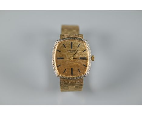 A gents Longines 9ct gold manual wind wristwatch, the rounded rectangular gold dial signed 'Longines' with black baton marker