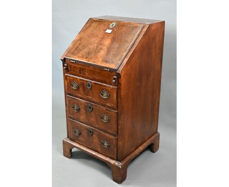 A diminutive antique Queen Anne style walnut bureau, the fall enclosing a fitted interior of drawers and niches centred by a 