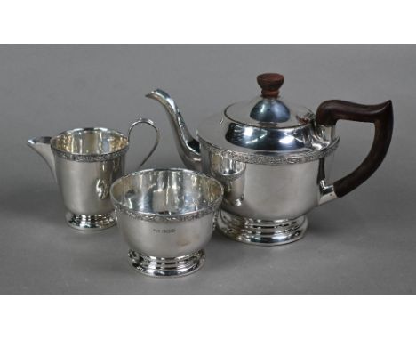 A silver three-piece bachelor tea service with Celtic strapwork banding, composite handle and finial, Viner's Ltd., Sheffield
