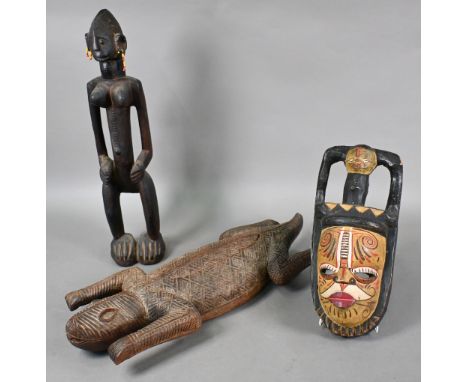 An African tribal carved wood female fertility figure, 57 cm high, to/w a trinket box carved as a crocodile, 65 cm long and a