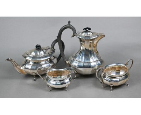 A heavy quality silver four-piece tea service of oval form with vertical facets, on pad feet, with composite handles and fini