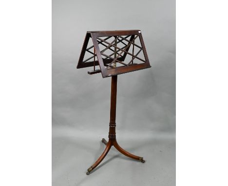 A Victorian mahogany double sided adjustable easel music stand, raised on a brass rise and fall support to a tripod base, goo