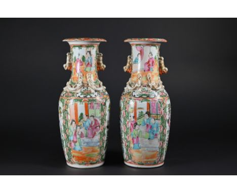 A pair of 19th century Chinese Canton famille rose vases, late Qing dynasty, each applied with moulded gilded karashishi lion