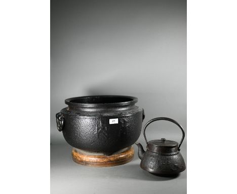 A large Japanese cast iron tripod hibachi (traditional brazier) cast with key-fret thunder pattern banding and two-character 